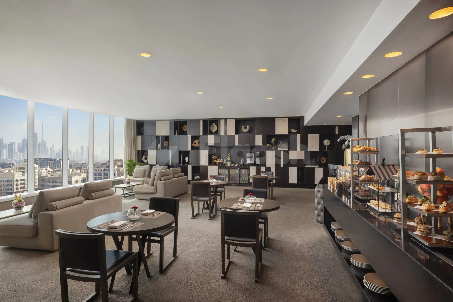 Restaurant interior at Signature by Sanjeev Kapoor Dubai featuring round wooden tables, black leather chairs, and floor-to-ceiling
