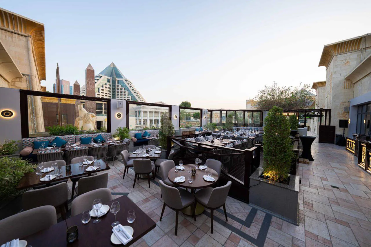 Rooftop terrace at Ashas Restaurant Dubai with stone tile flooring and city skyline view