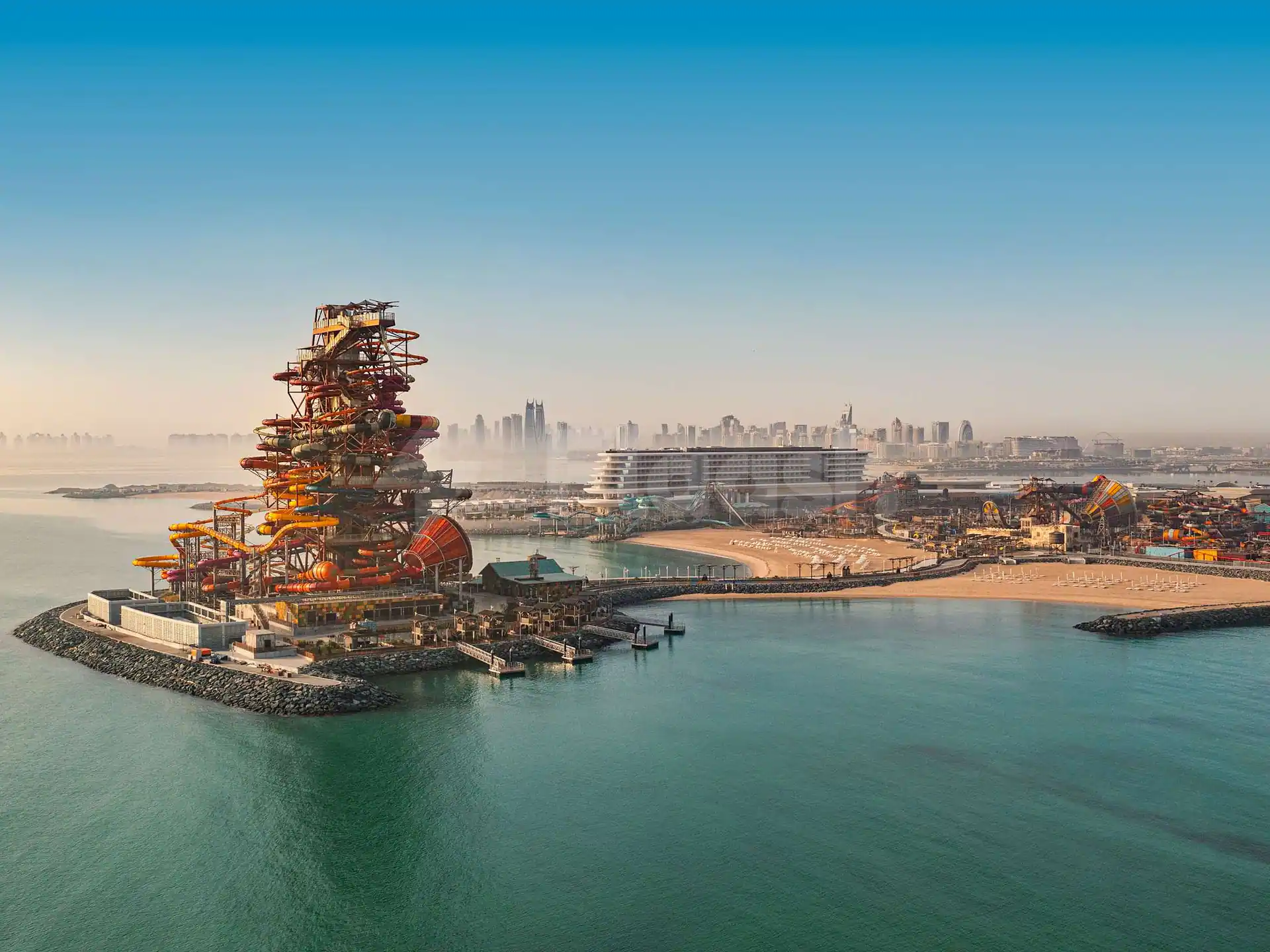 Rooftop terrace at Rixos Premium Qetaifan Island North in Doha overlooking a water park with multi-coloured slides