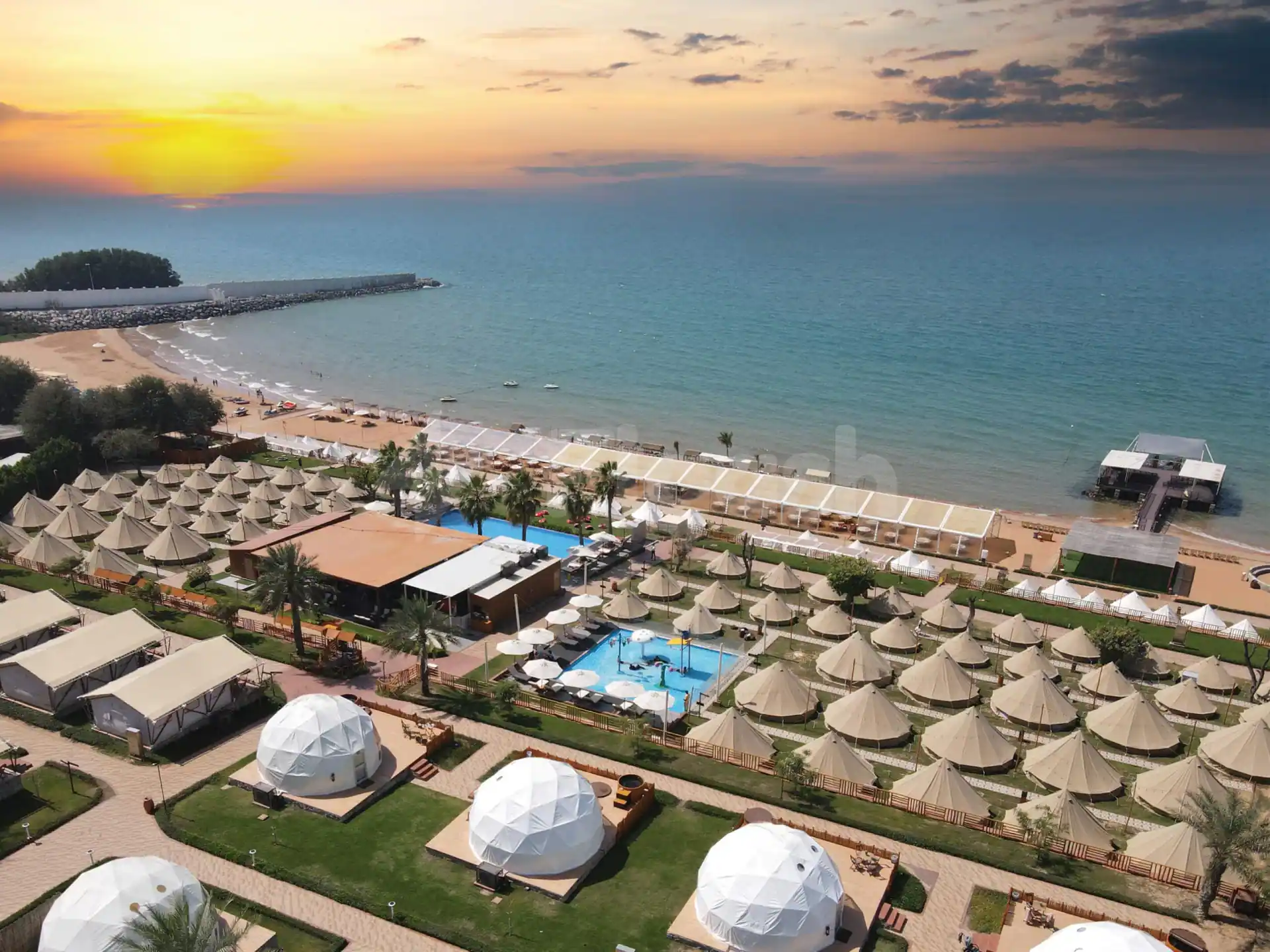 Beachfront terrace at Bm Beach Resort Ras Al Khaimah with white dome tents and turquoise sea view