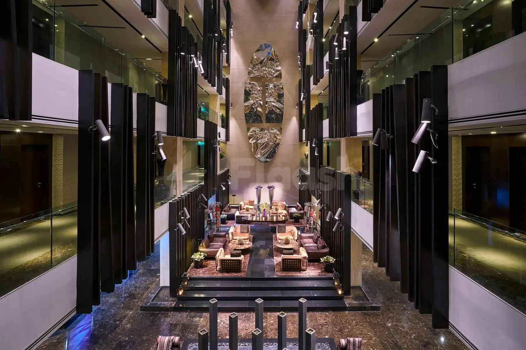 Multi-level atrium entrance hall at Signature by Sanjeev Kapoor Restaurant Dubai featuring black vertical slats and a large