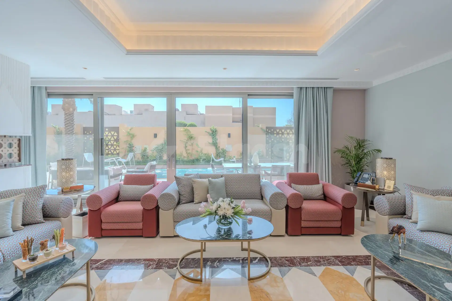 Lounge area at Vivienda Hada Residences in Riyadh with geometric tile floor and pool view