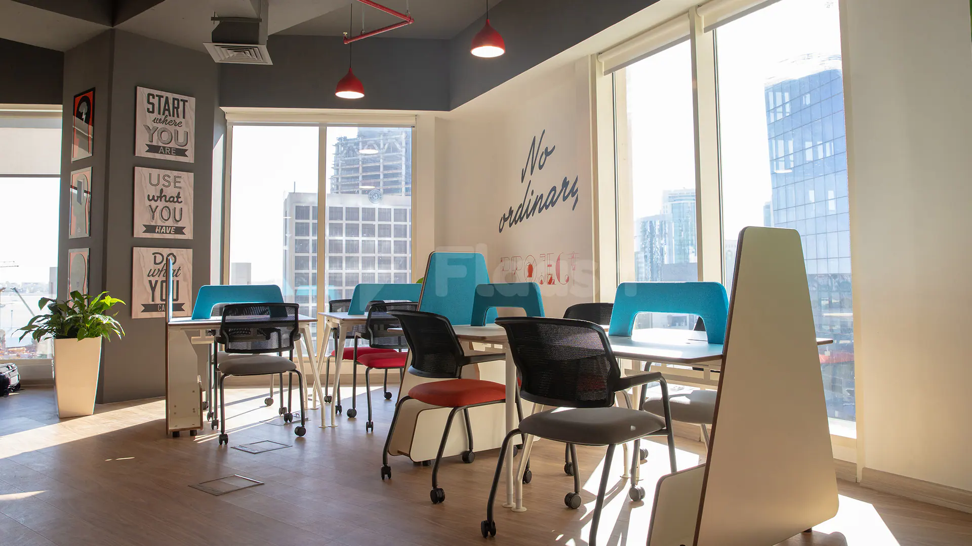 Modern meeting room at Nestwork Msheireb in Doha featuring large windows with city views and motivational wall art