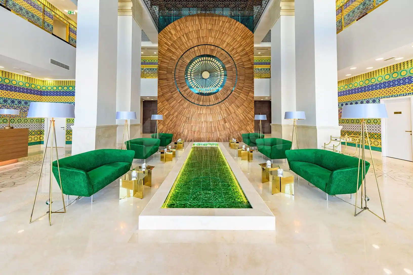 Entrance hall at Time Rako Hotel Qatar in Doha with a long green-tiled water feature