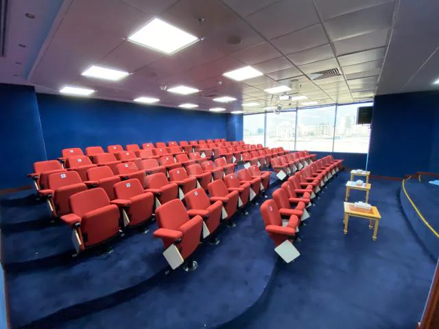 Meeting Room at Jeddah International Exhibition & Convention Center featuring tiered red upholstered seating and large windows