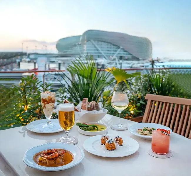 Rooftop terrace at Mika Restaurant Abu Dhabi with a white table set for dining and a modern building
