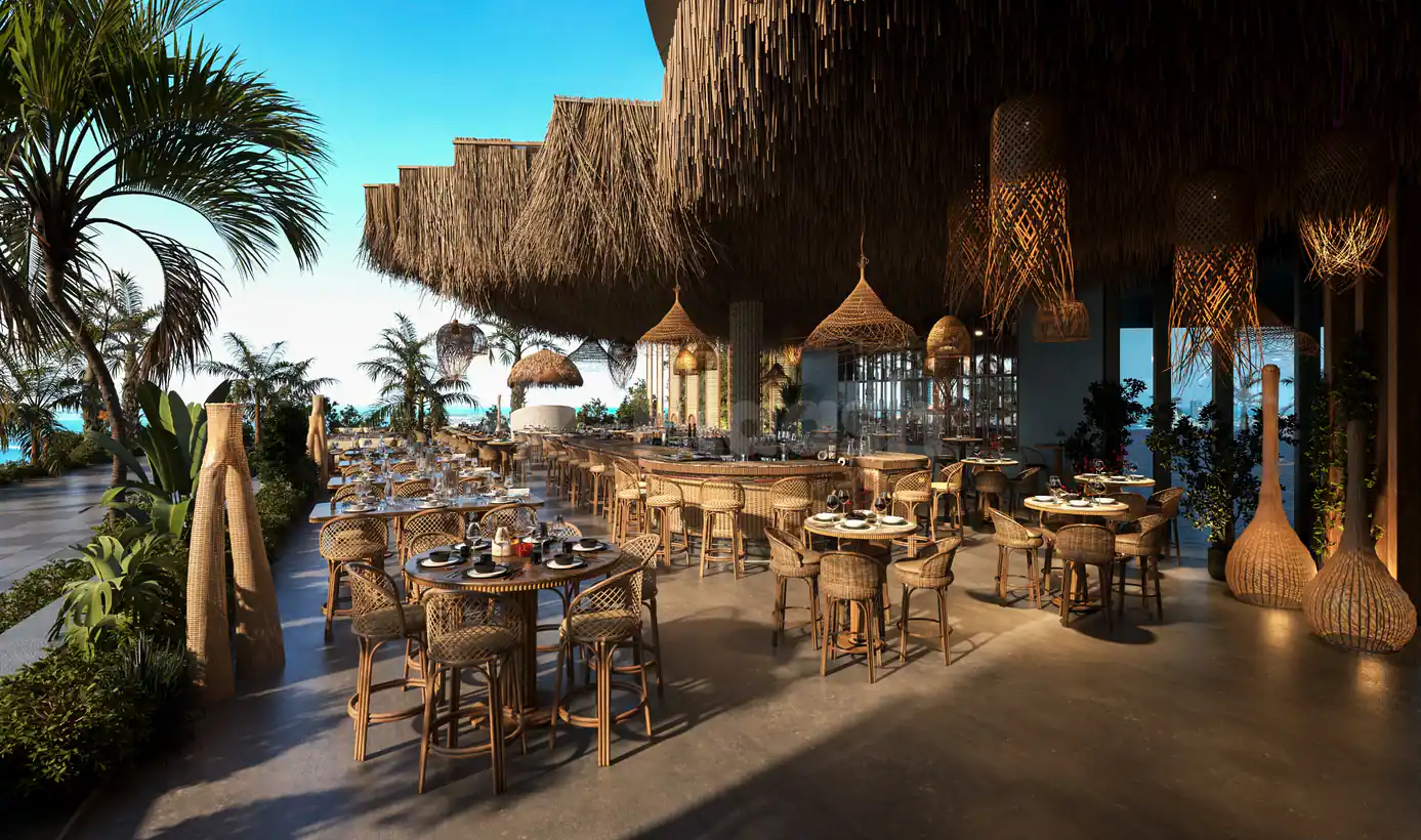 Terrace at Bar du Port Abu Dhabi featuring a layered thatched roof and hanging wicker lamps with ocean