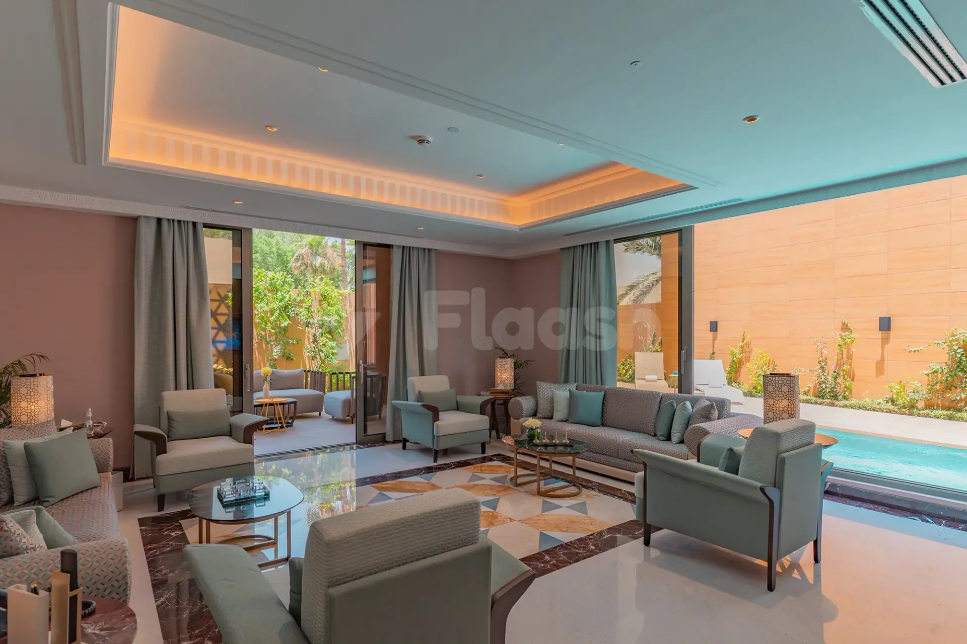 Lounge area at Vivienda Hada Residences in Riyadh with light blue ceiling and outdoor pool view