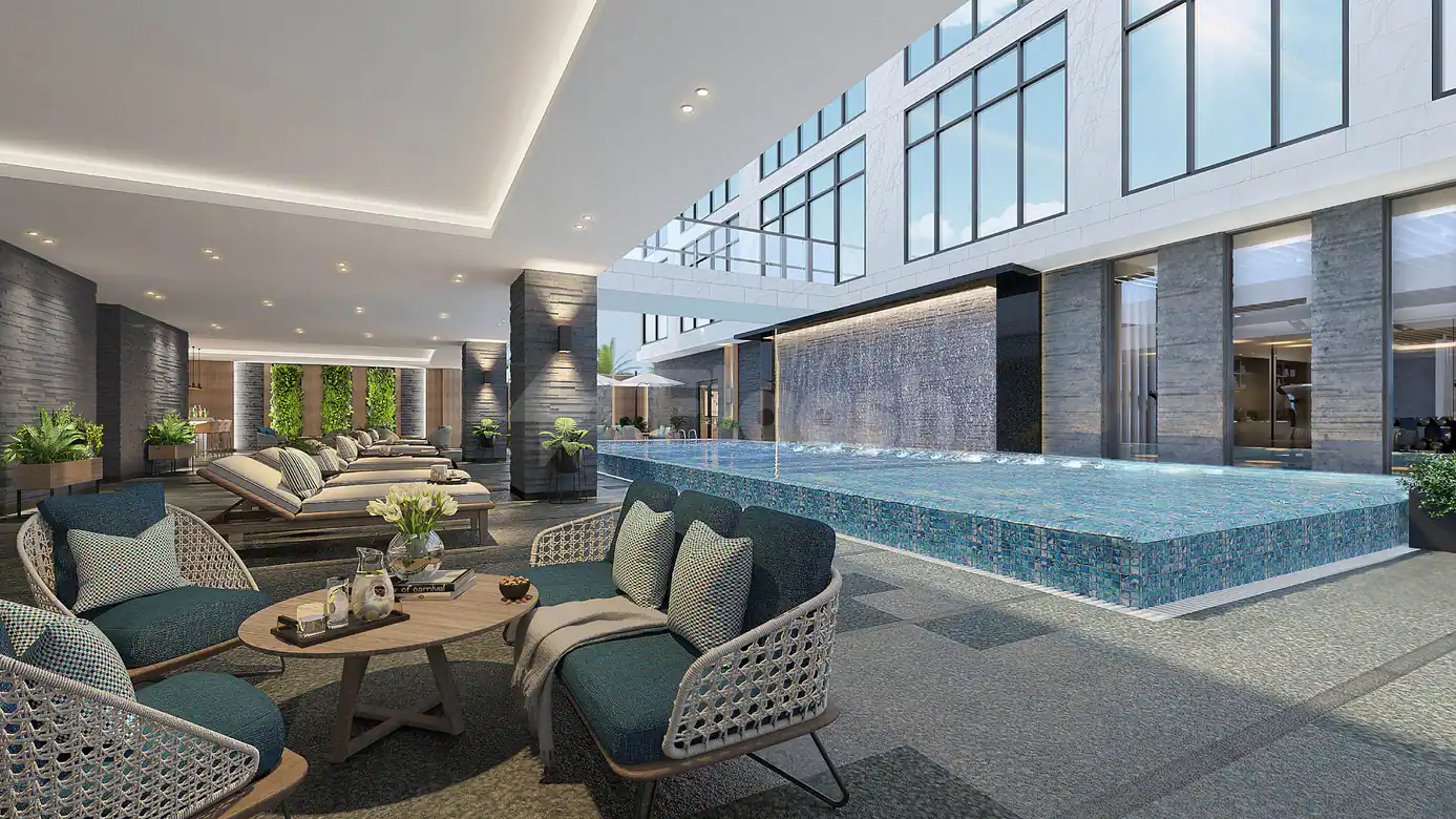 Indoor swimming pool at Four Points By Sheraton Jeddah featuring blue mosaic tiles and a backlit water feature