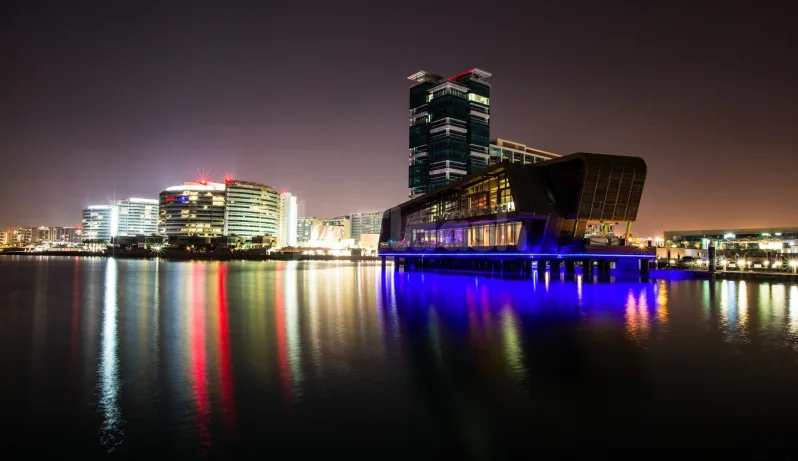 Rooftop terrace at Ornina Arabian Lounge in Abu Dhabi with cantilevered waterfront structure over calm water