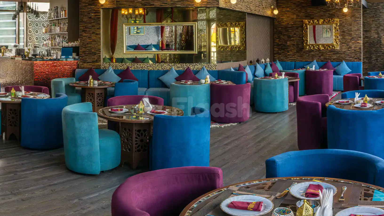 Restaurant at Ornina Arabian Lounge in Abu Dhabi with stone walls and gold-framed mirrors