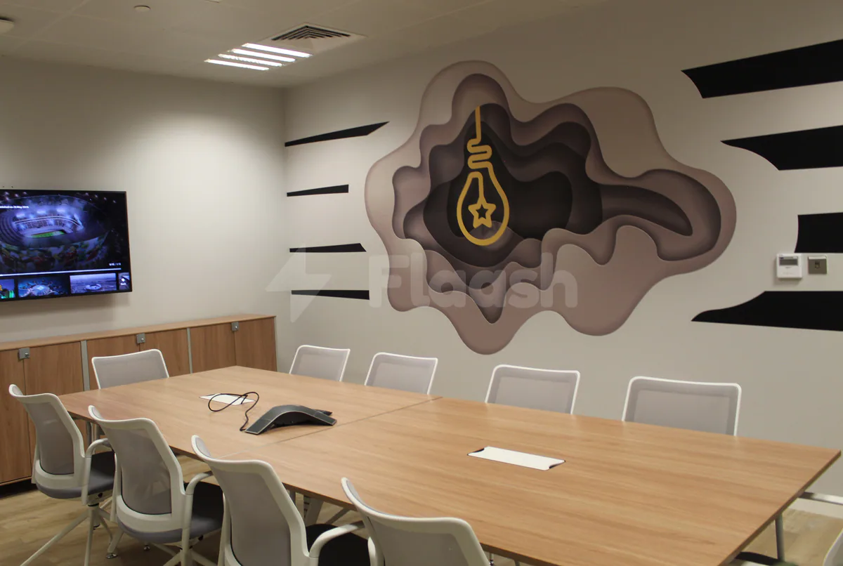 Boardroom at Workaholics Qatar in Doha with 3D wall art featuring a yellow lightbulb motif