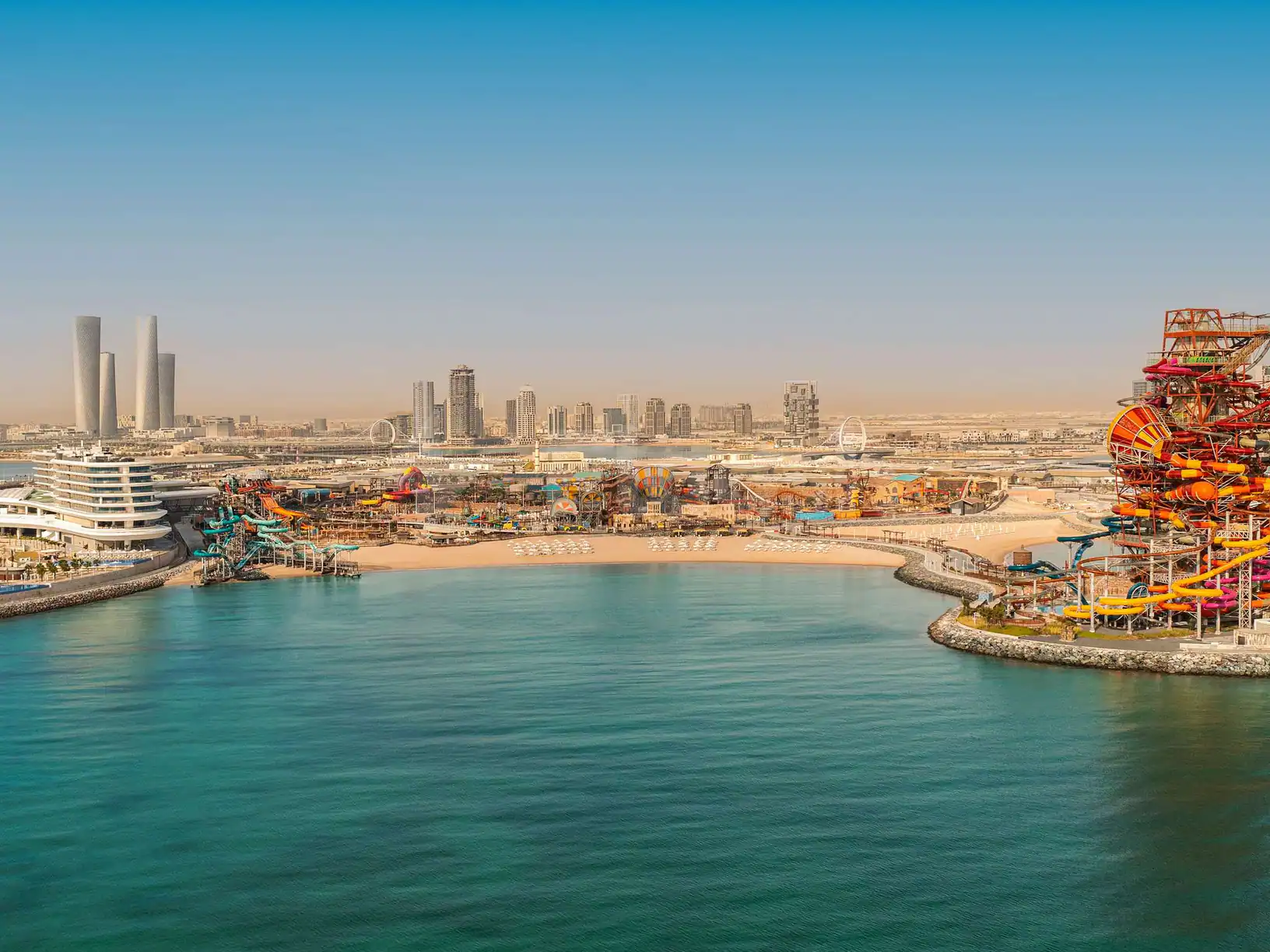 Rooftop terrace at Rixos Premium Qetaifan Island North in Doha overlooking a water park with orange and yellow
