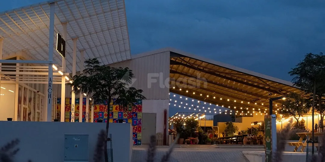 Rooftop terrace at Jax 01 Riyadh featuring a metal roof structure with string lights and white support columns