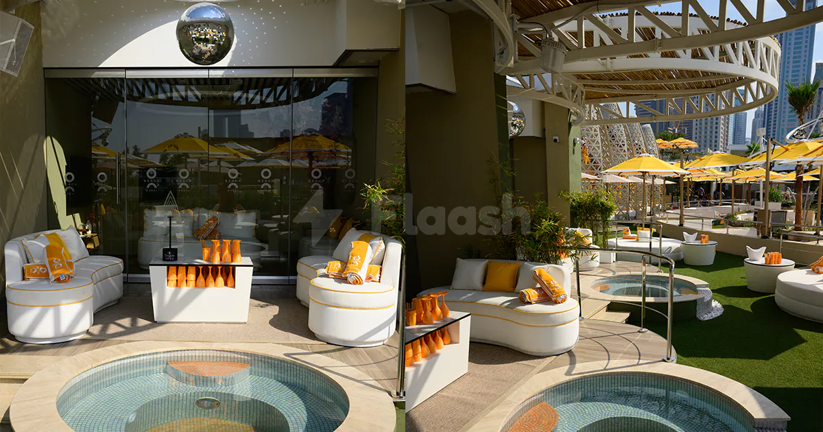 Rooftop terrace at O Beach Dubai featuring circular mosaic-tiled pools and white curved lounge seating under a sunlit