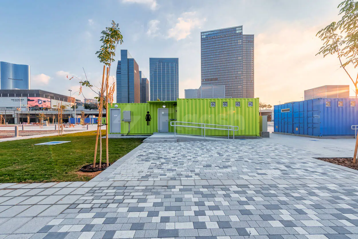 Park at Active Al Maryah Island Sports & Recreation in Abu Dhabi with green shipping container restrooms and paved