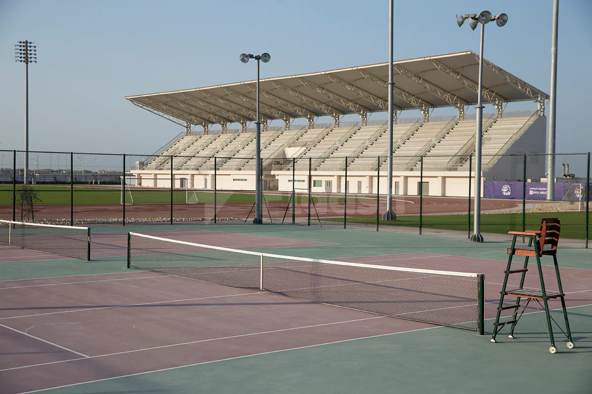 Tennis court at NYU Abu Dhabi Athletic Field in Abu Dhabi with covered stadium seating