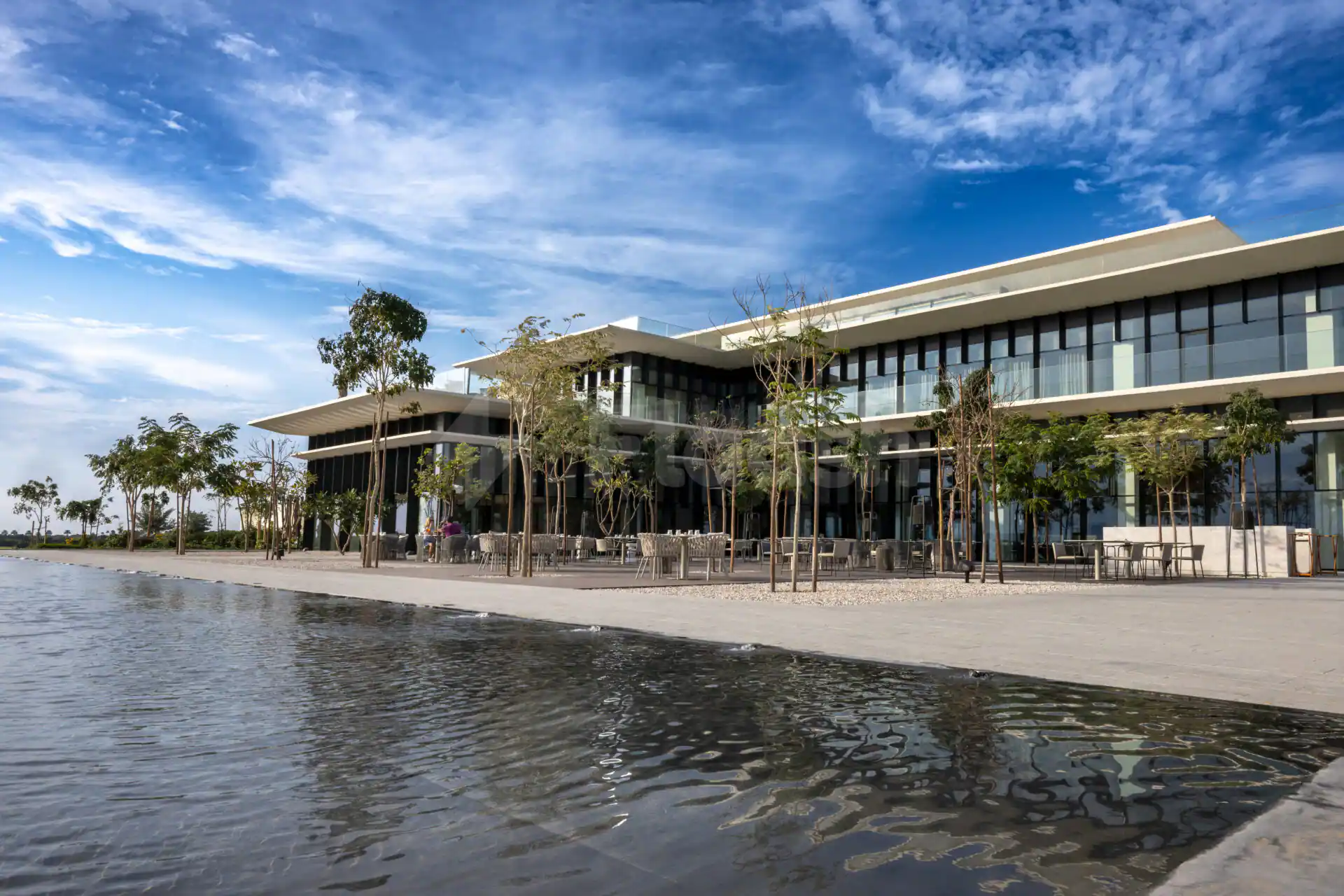Rooftop terrace at Al Zorah Golf Club in Ajman with a reflecting water feature