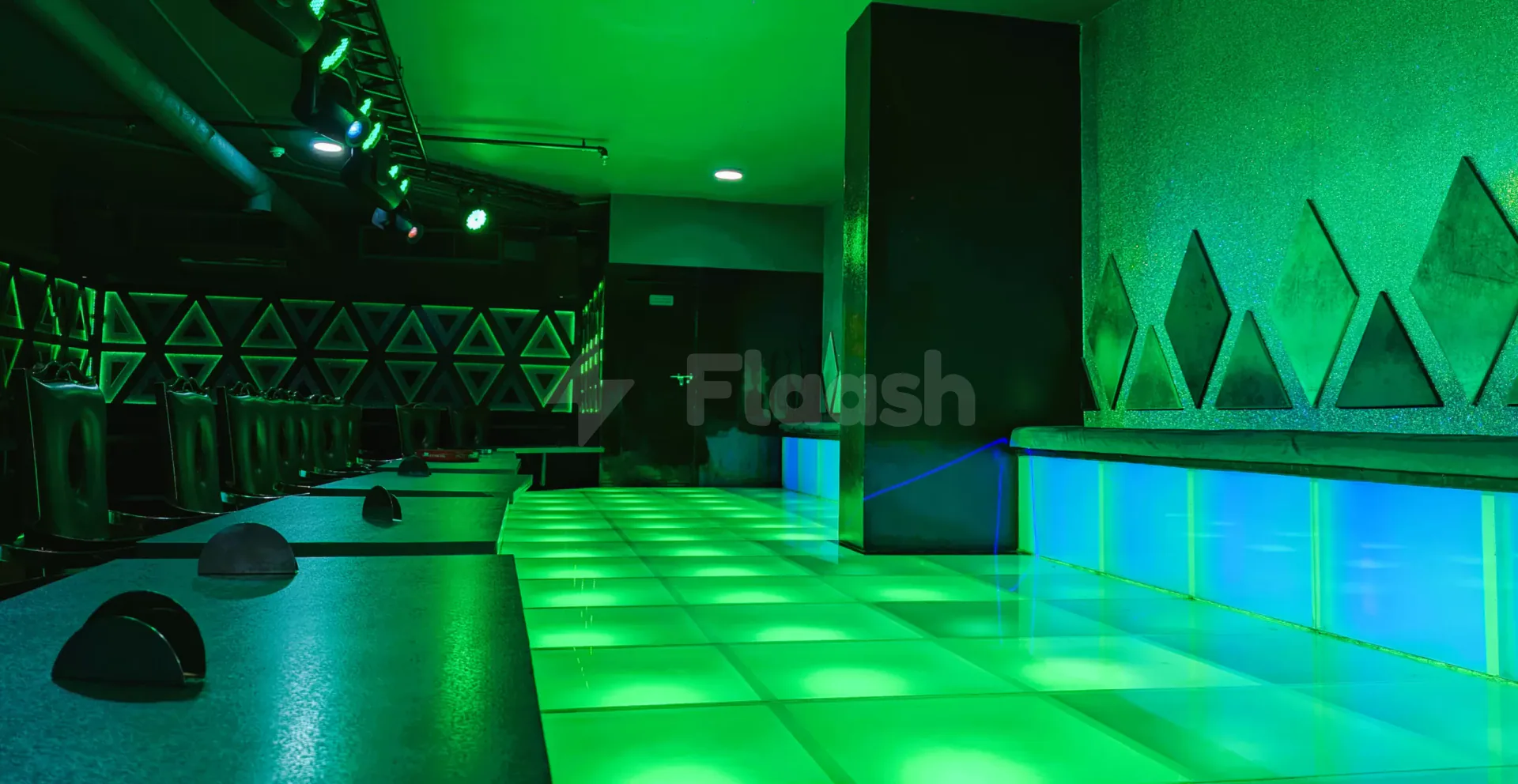 Ballroom at Fortis Hotel Fujairah featuring a green LED-lit floor and geometric triangular wall panels with glitter texture