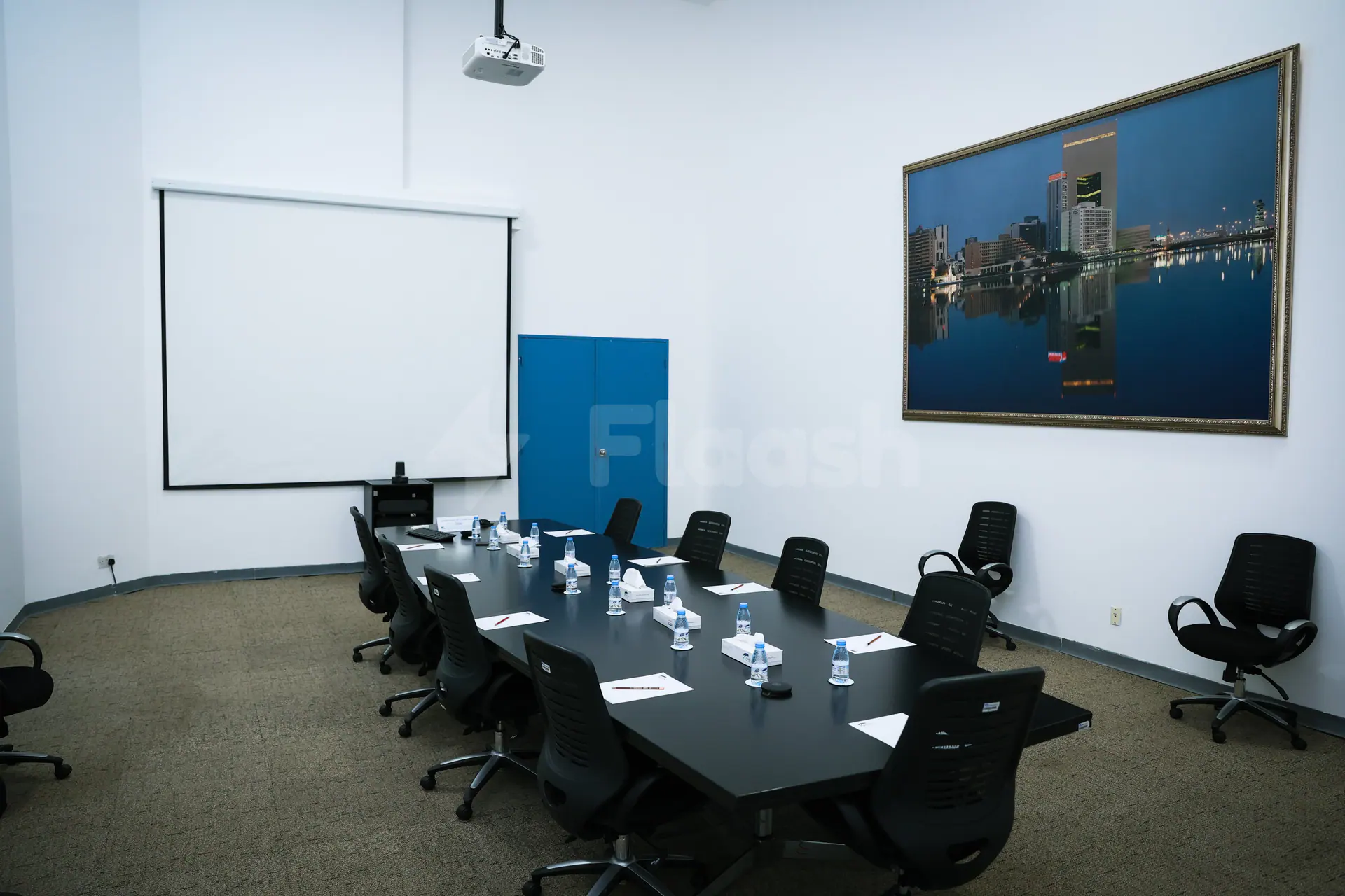 Boardroom at Jeddah International Exhibition & Convention Center featuring a black table, black chairs, a projection screen