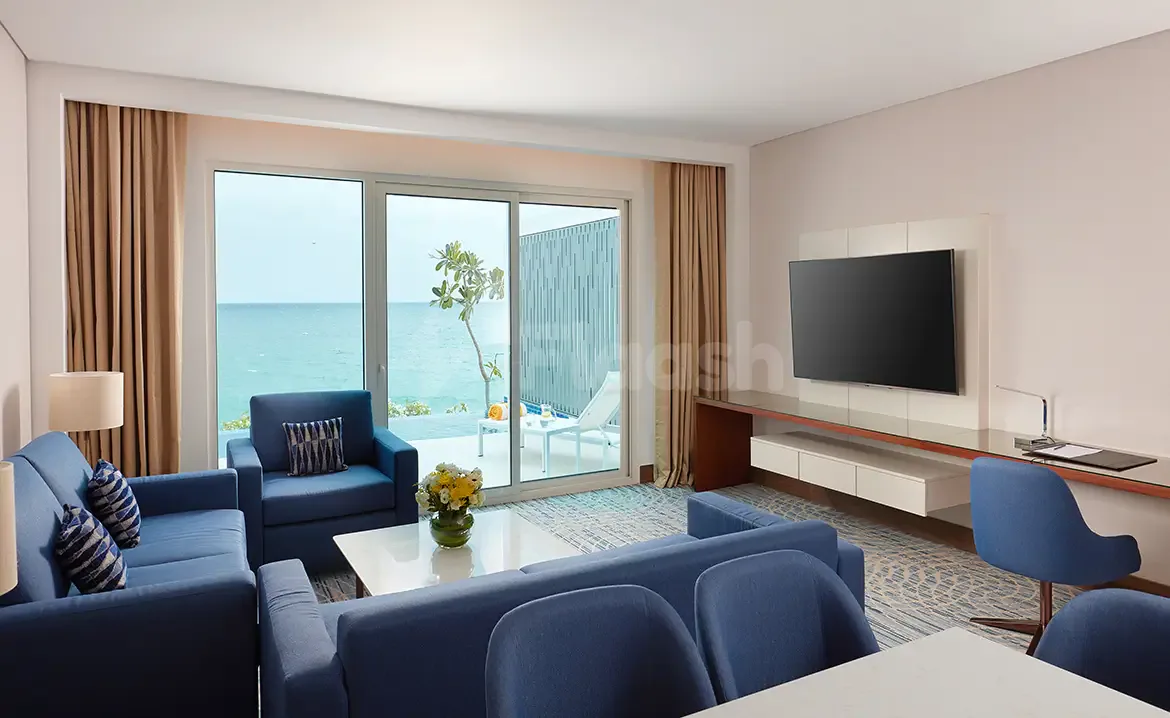 Meeting room at Royal M Hotel & Resort Al Aqah Beach in Fujairah with ocean view through sliding glass
