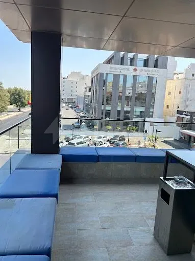 Rooftop terrace at Basix Coworking Space Jeddah with glass railing and urban street view