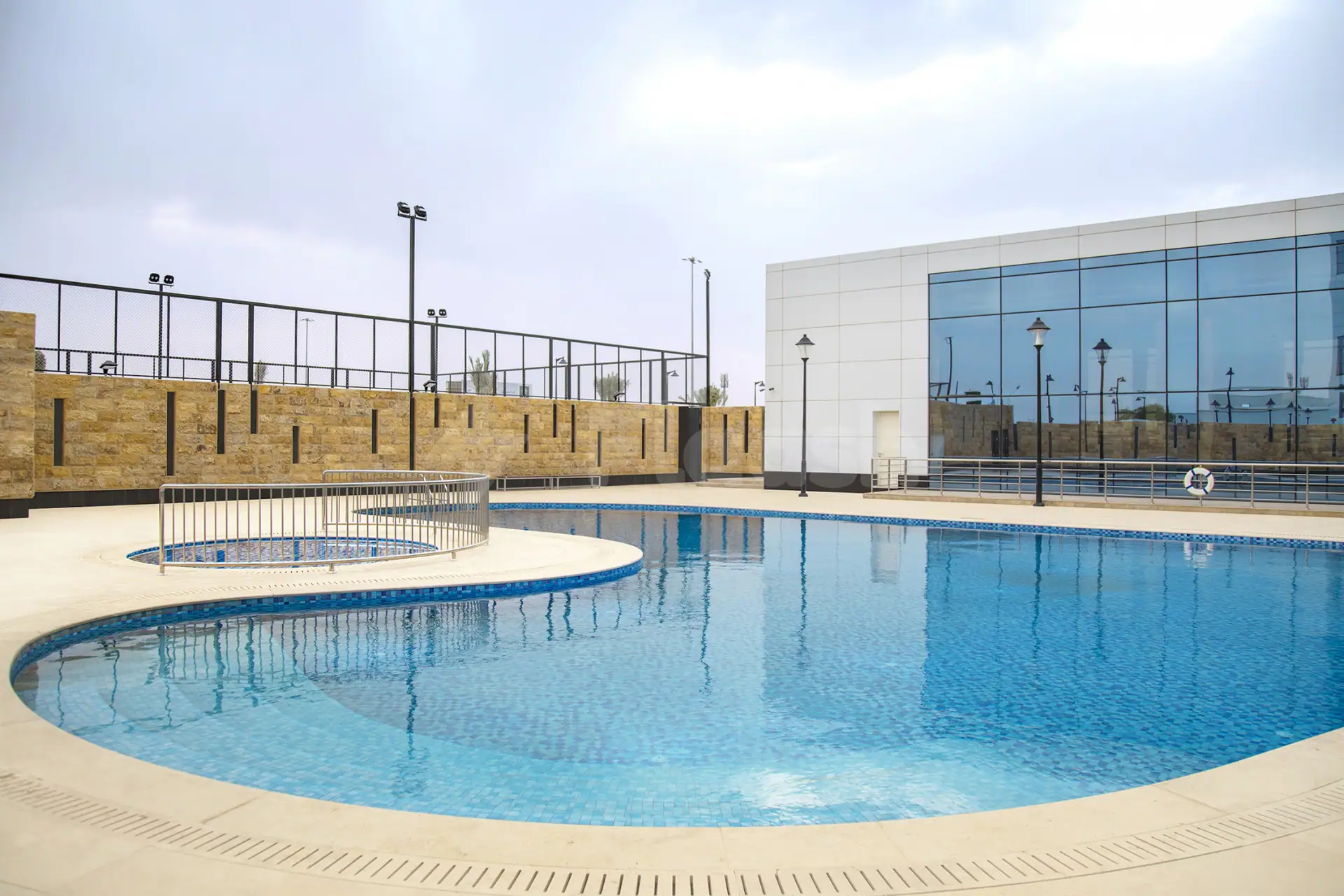 Swimming pool at Cristal Amaken Hotel Riyadh featuring a circular inset pool and stainless steel railing