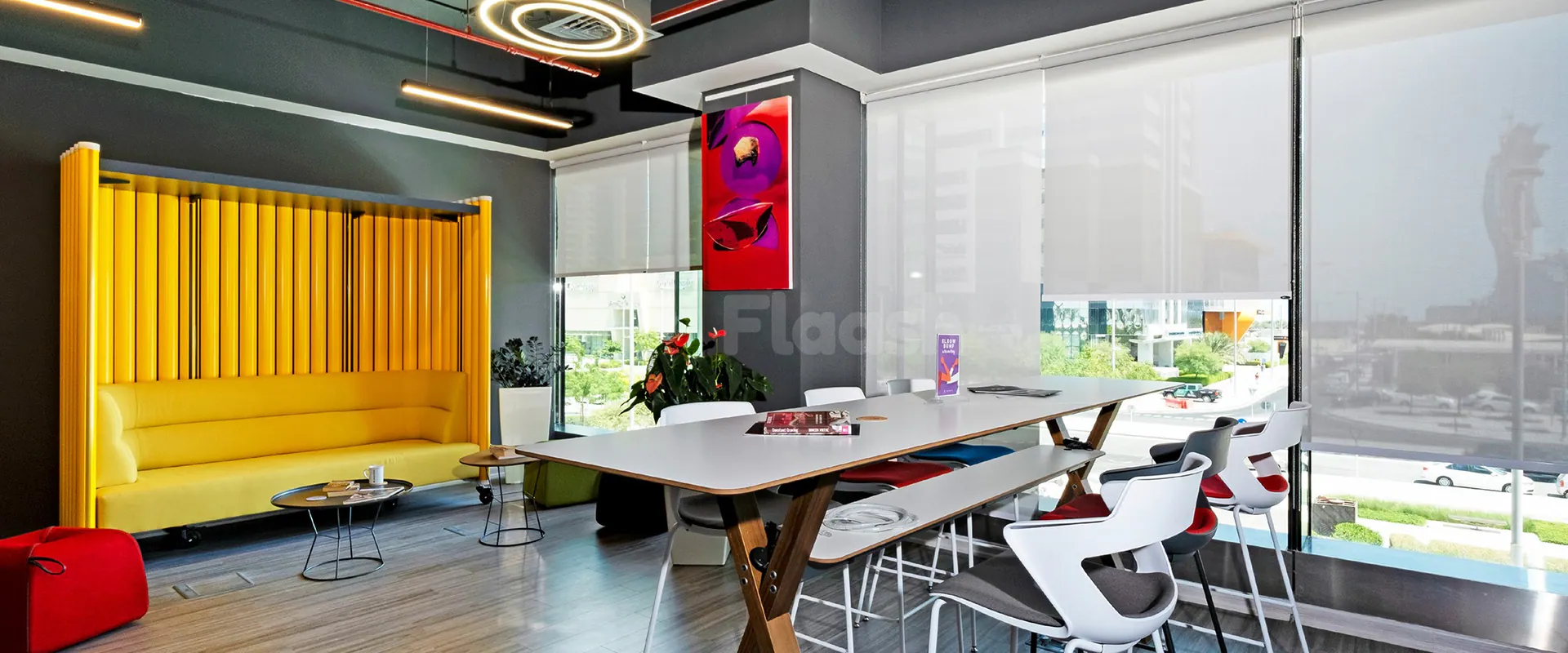 Meeting room at Nestwork Burj Alfardan Lusail in Lusail with yellow panel backdrop and city view