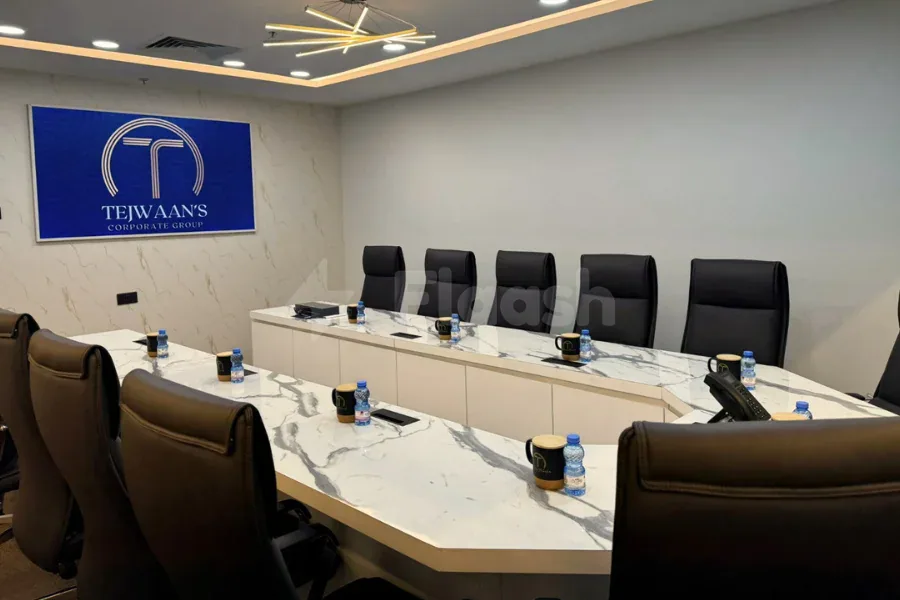 Boardroom at Tejwaans Business Centre in Doha featuring a marble conference table and black leather chairs