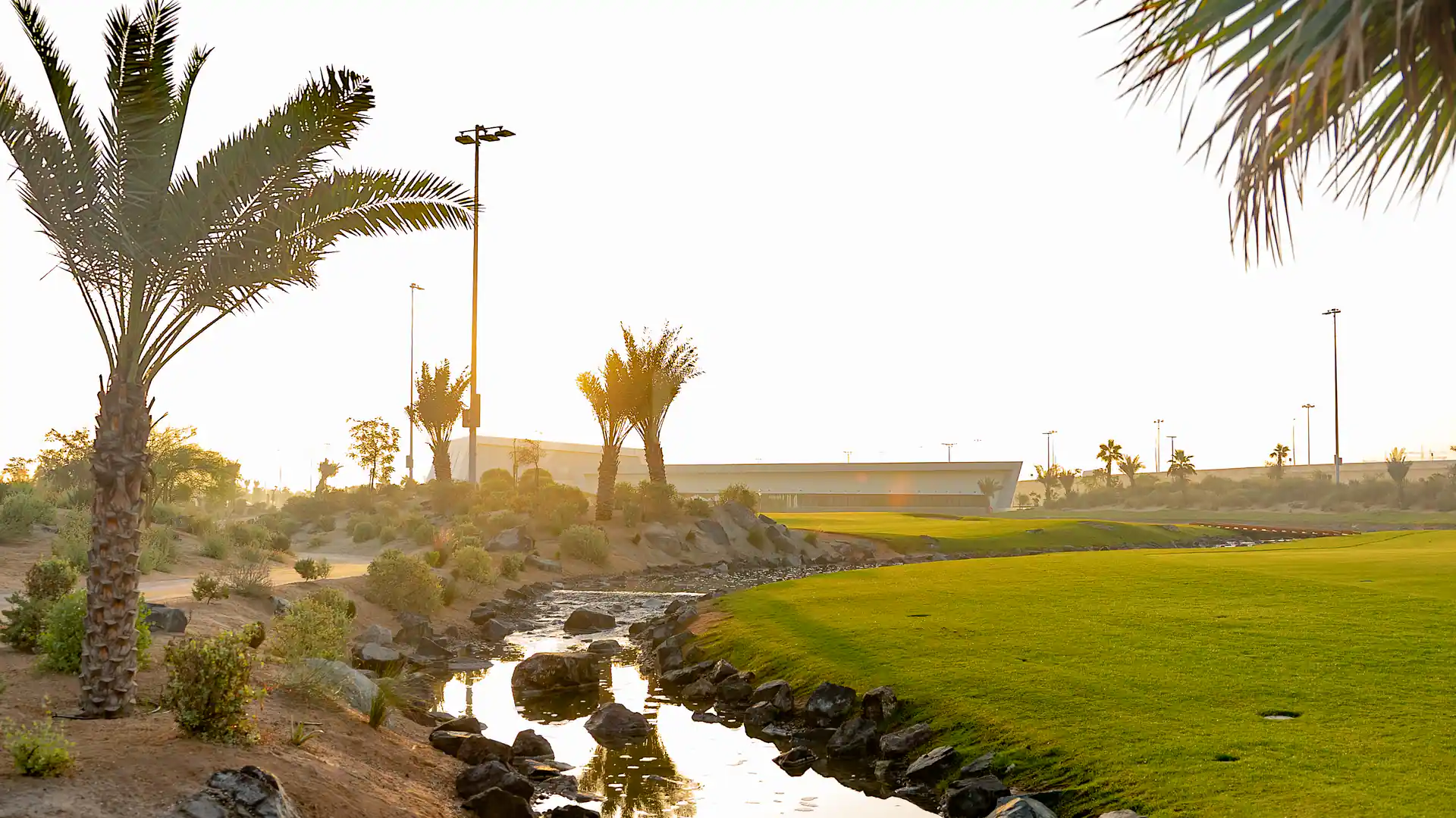 Garden at Yas Acres Golf & Country Club in Abu Dhabi with a small rocky stream