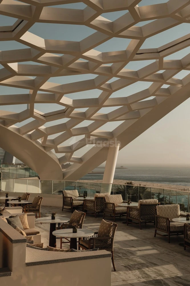 Rooftop lounge at Rosewood Doha, Lusail, with geometric canopy and ocean view
