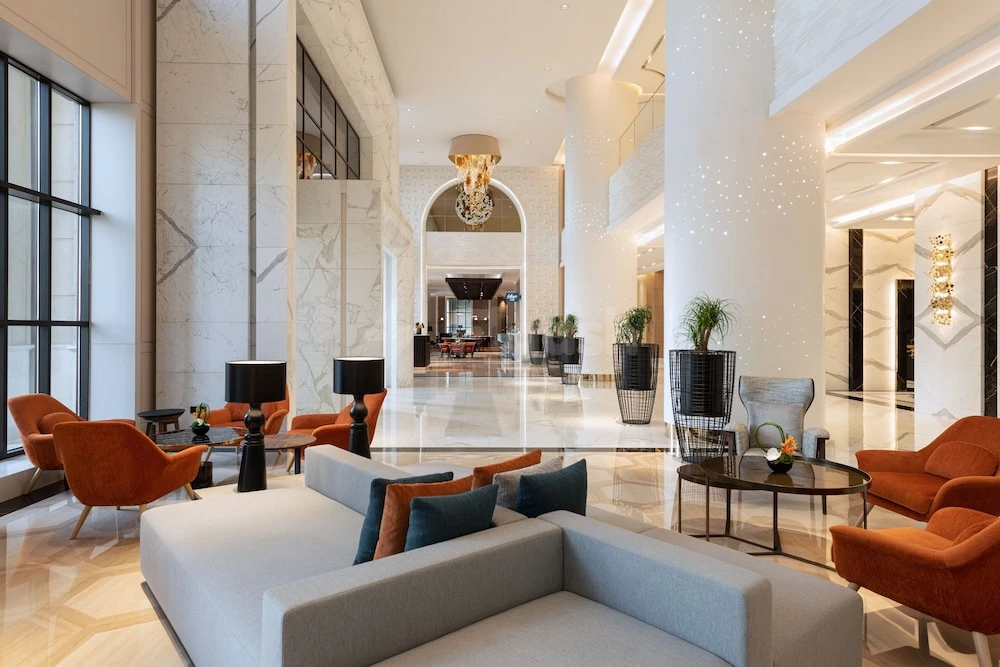 Grand marble lobby at Le Royal Méridien Place Vendôme Lusail, Lusail, with arched entryway and modern