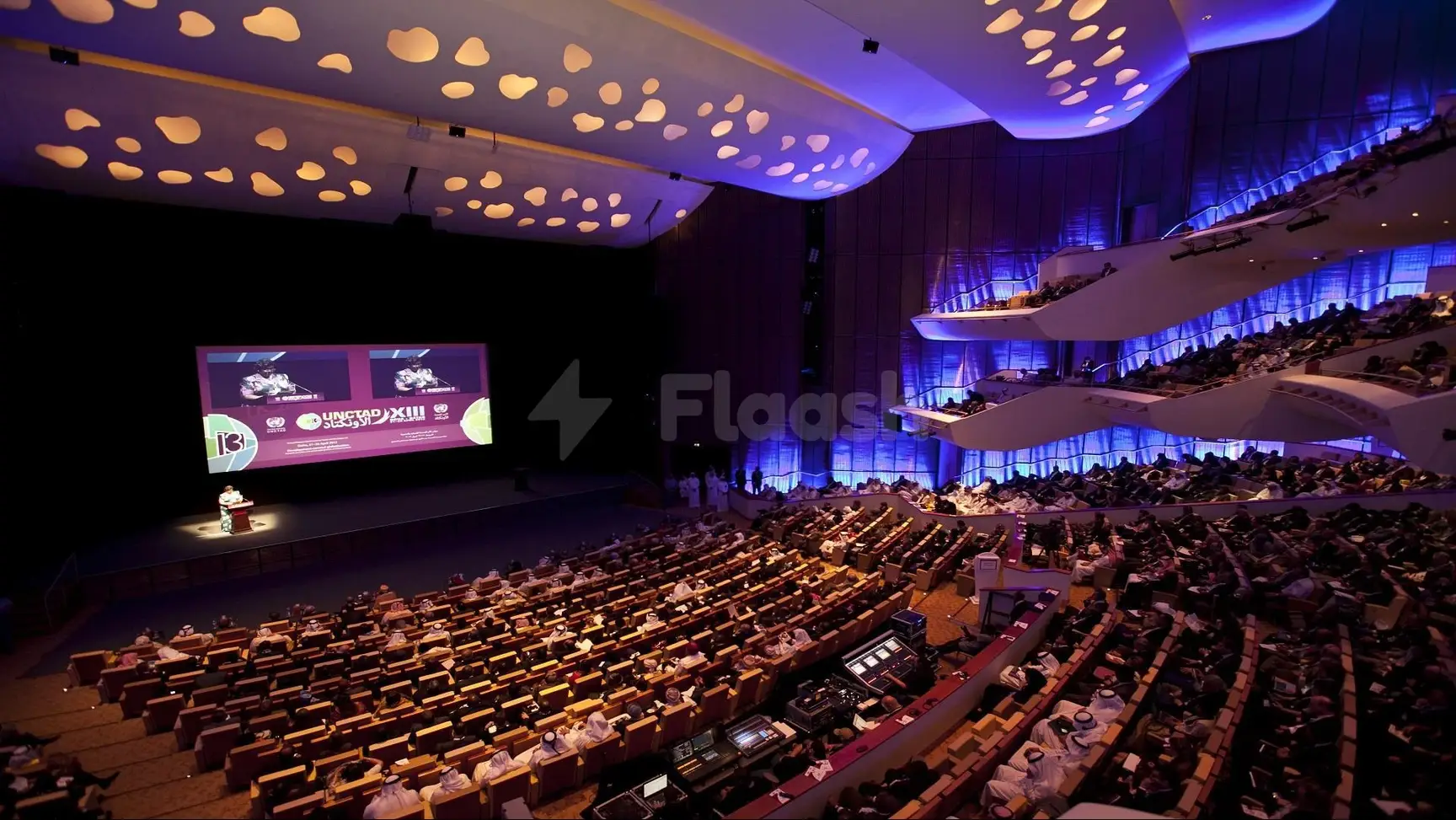 Grand auditorium at Qatar National Convention Centre, Doha, with tiered seating and illuminated ceiling cutouts