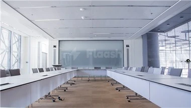 Conference room at Doha Exhibition and Convention Center, Doha, featuring a large screen and U-shaped table arrangement