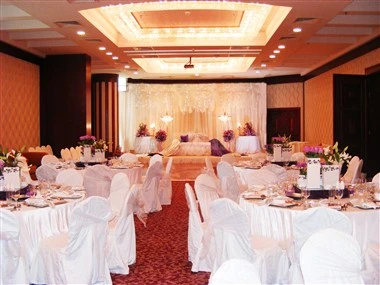 Banquet hall at Swiss-Belhotel Doha, Doha, with white-draped tables and illuminated ceiling centerpiece