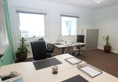 Boardroom at Regus - Doha Airport, Doha, with large windows and potted plants on desks