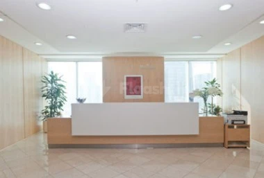 Modern reception area at Regus - Doha West Bay, Doha, featuring wooden paneling and a minimalist white desk