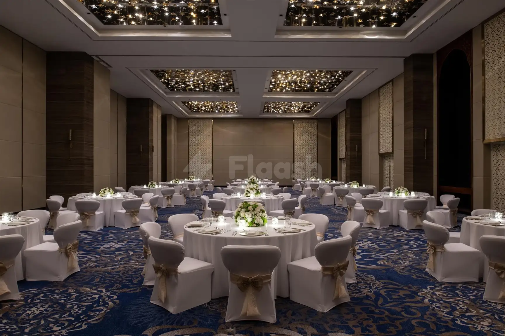 Banquet hall at Abesq Doha Hotel & Residences, Doha, with white tablecloths and starlit ceiling panels