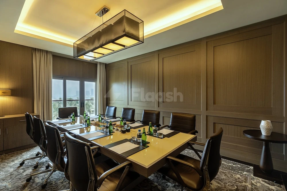 Conference room at Intercontinental Doha Beach & Spa, Qatar, with modern lighting and wooden paneling