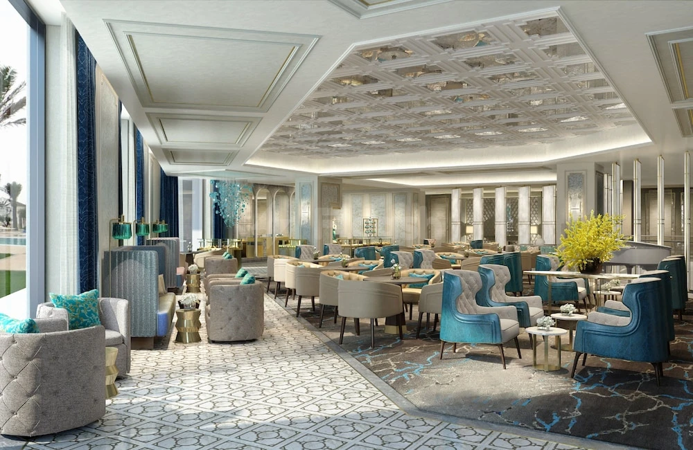 Lobby lounge at Intercontinental Doha Beach & Spa, Qatar, with turquoise armchairs and geometric ceiling panels