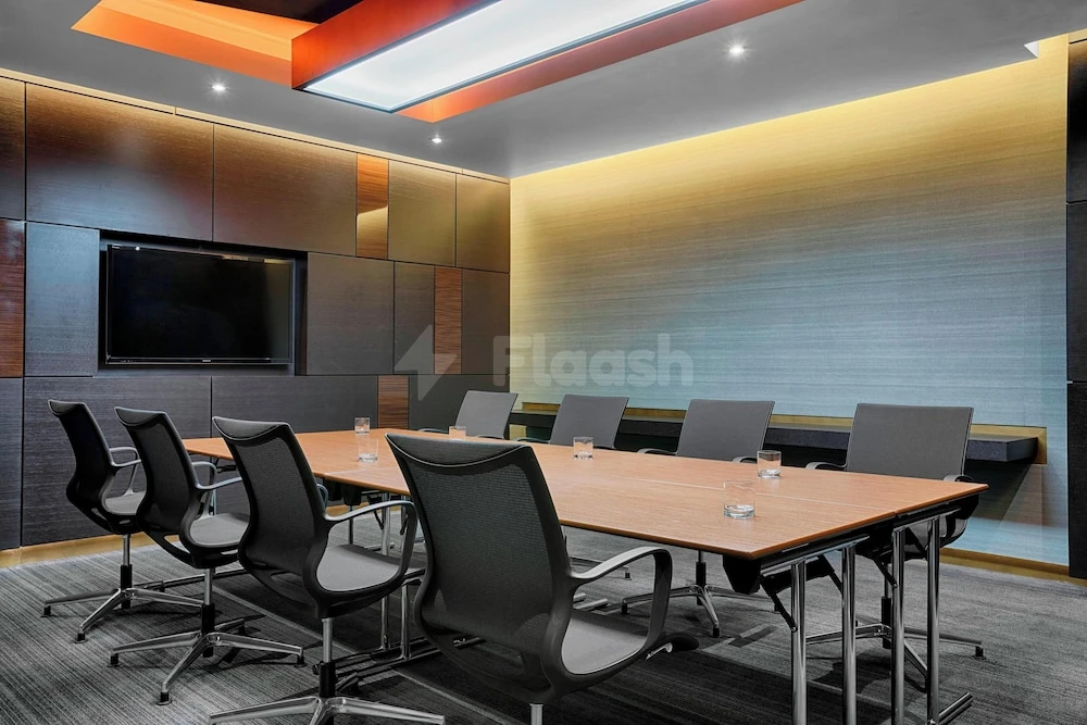 Meeting room at The Westin Doha Hotel & Spa, Doha, with modern wooden table and black mesh chairs under