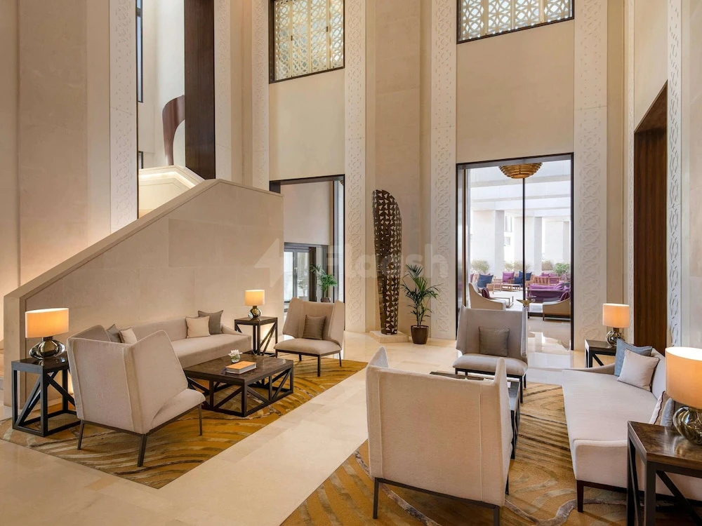 Lobby at Alwadi Hotel Doha MGallery By AccorHotels, Doha, with tall columns and geometric window screens