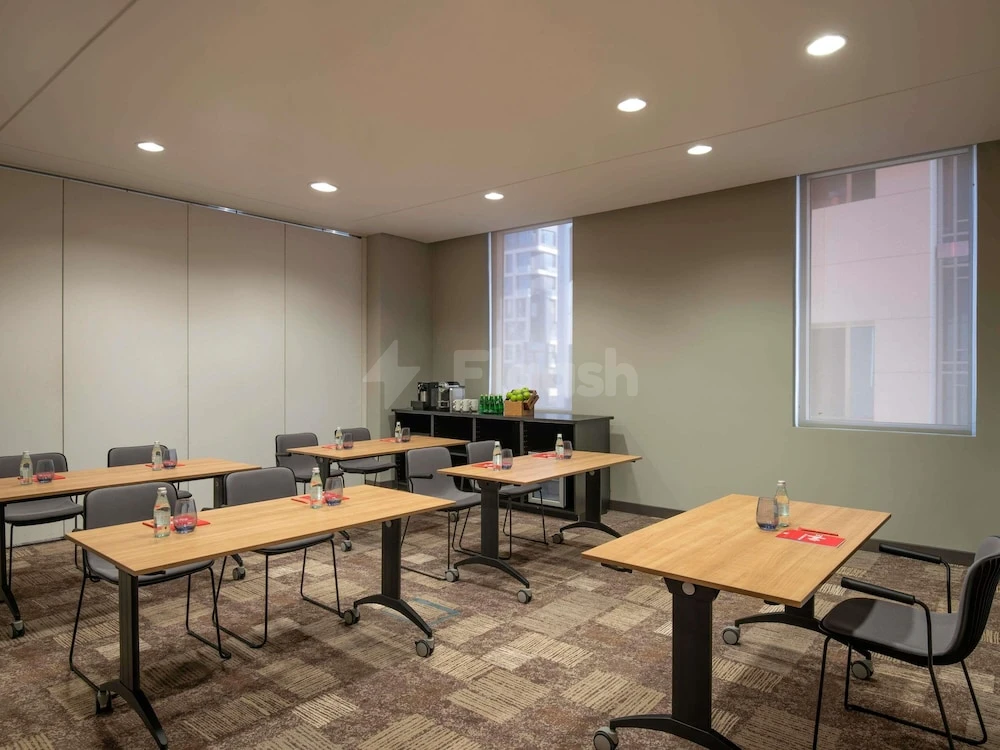 Meeting room at Adagio Doha, Doha, with wooden tables and city-view windows