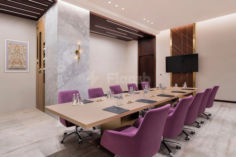 Boardroom at Velero Hotel Doha Lusail, Lusail, with marble pillar and purple chairs