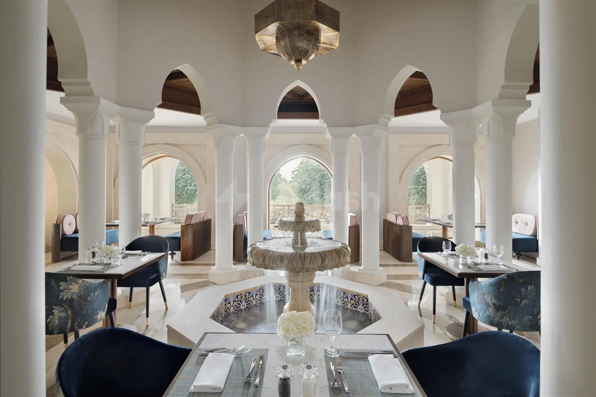 Dining room at InterContinental Durrat Al Riyadh Resort & Spa, Riyadh, featuring central fountain and arched columns with blue