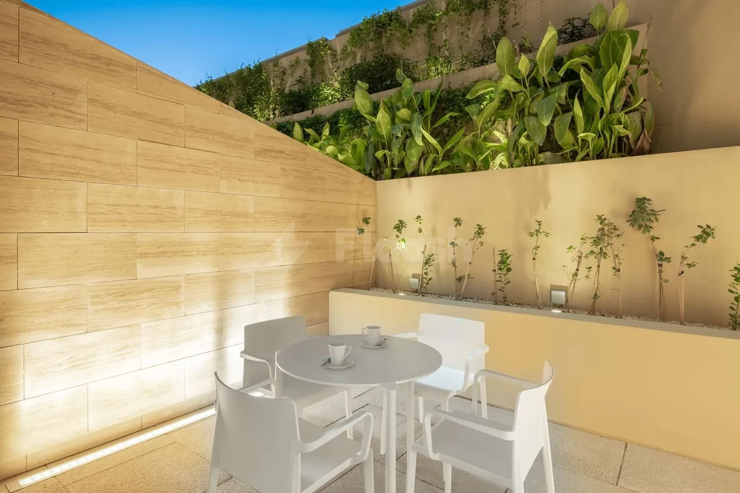Outdoor terrace at Radisson Blu Hotel and Residence Riyadh D.Q., Riyadh, with lush green wall and white