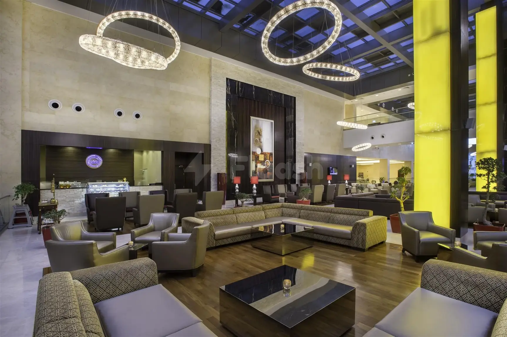 Lobby at Crowne Plaza Riyadh RDC Hotel & Convention, Riyadh, featuring circular crystal chandeliers and vibrant yellow light pillars
