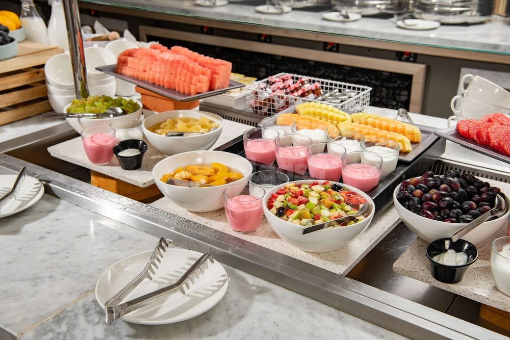 Buffet breakfast station at Park Inn by Radisson Makkah Aziziyah, Makkah, featuring fresh fruit platters and yogurt cups