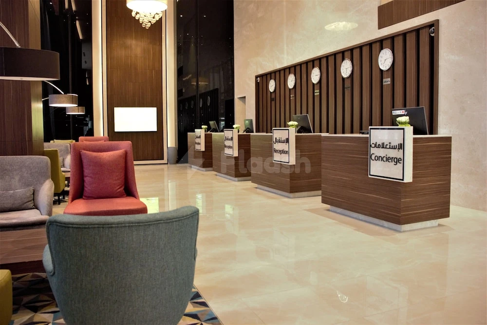 Lobby at Park Inn by Radisson Makkah Aziziyah, Makkah, with wooden reception desks and modern seating area