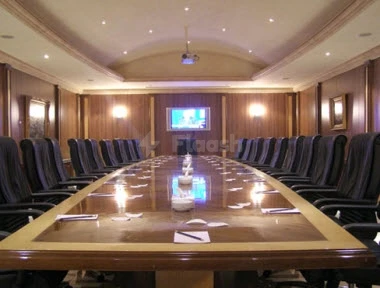 Boardroom at Sunset Jeddah, Jeddah, with polished wood table and recessed ceiling lighting